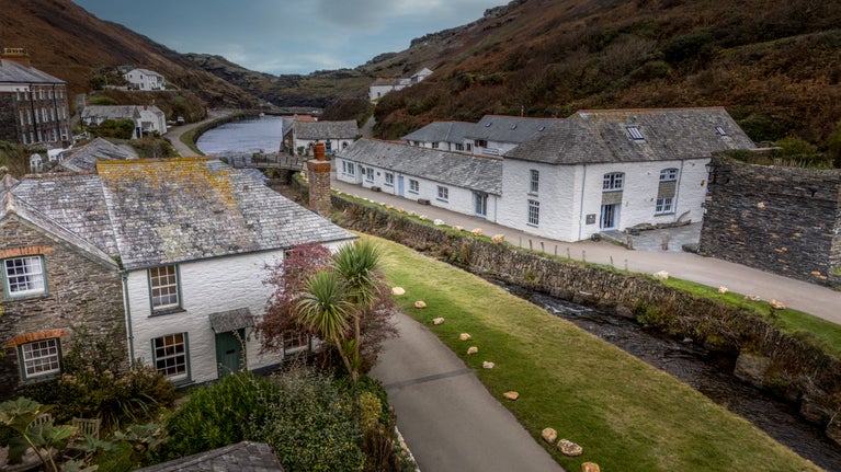 An aerial view of Harbour View (on the left) and Boscastle village, with the River Valency passing next to the cottage, Cornwall